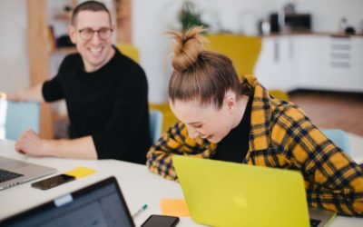 Man and woman laughing in the office