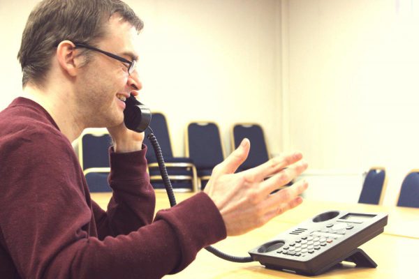 man speaking on the telephone