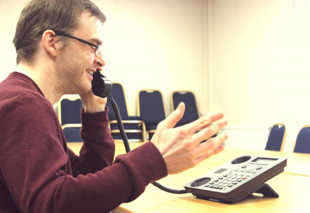 man speaking on the telephone