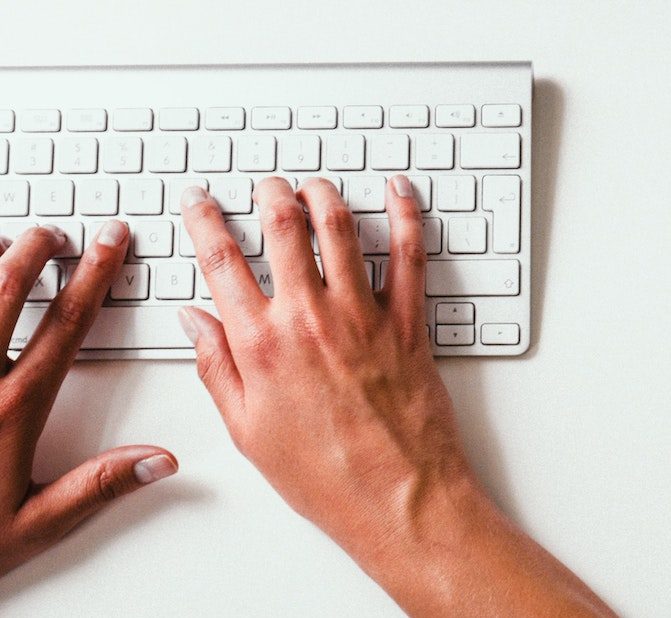 person typing on keyboard