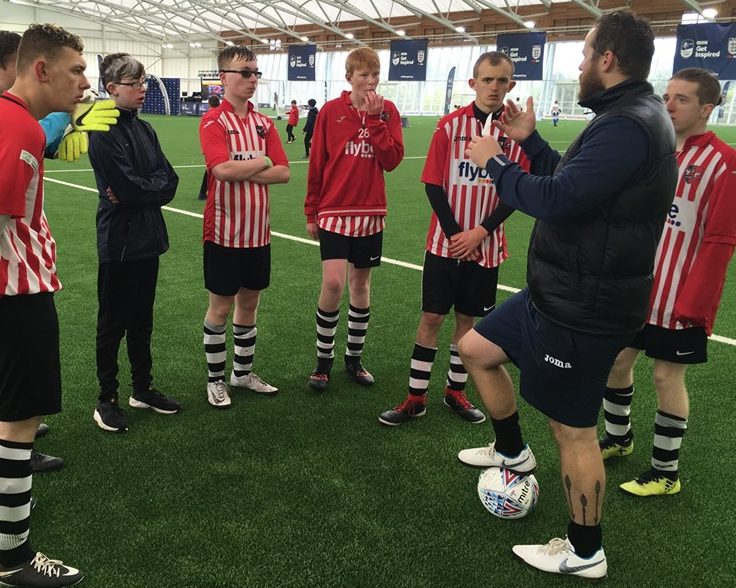 Deaf Community football team with thier volunteer and coach