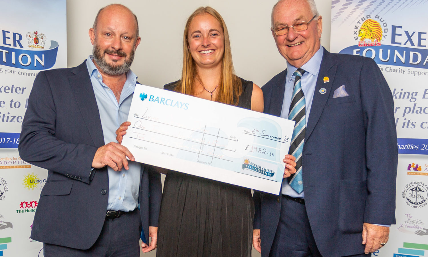 Living Options Fundraising Officer with two members of Exeter Community presenting her with a cheque for funds raised for the charity