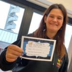 A living options debon volunteer holding up a certificate for becoming a Deaf Get Active buddy