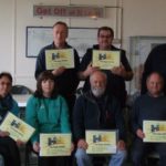 Team of people holding certificates for completing their Disability and Deaf Awareness Training at Geevor Tin Mine