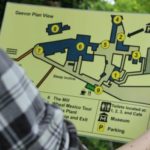 Person holding large print guide for a vistor attractions