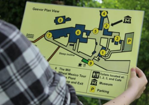 Person holding large print guide for a vistor attractions