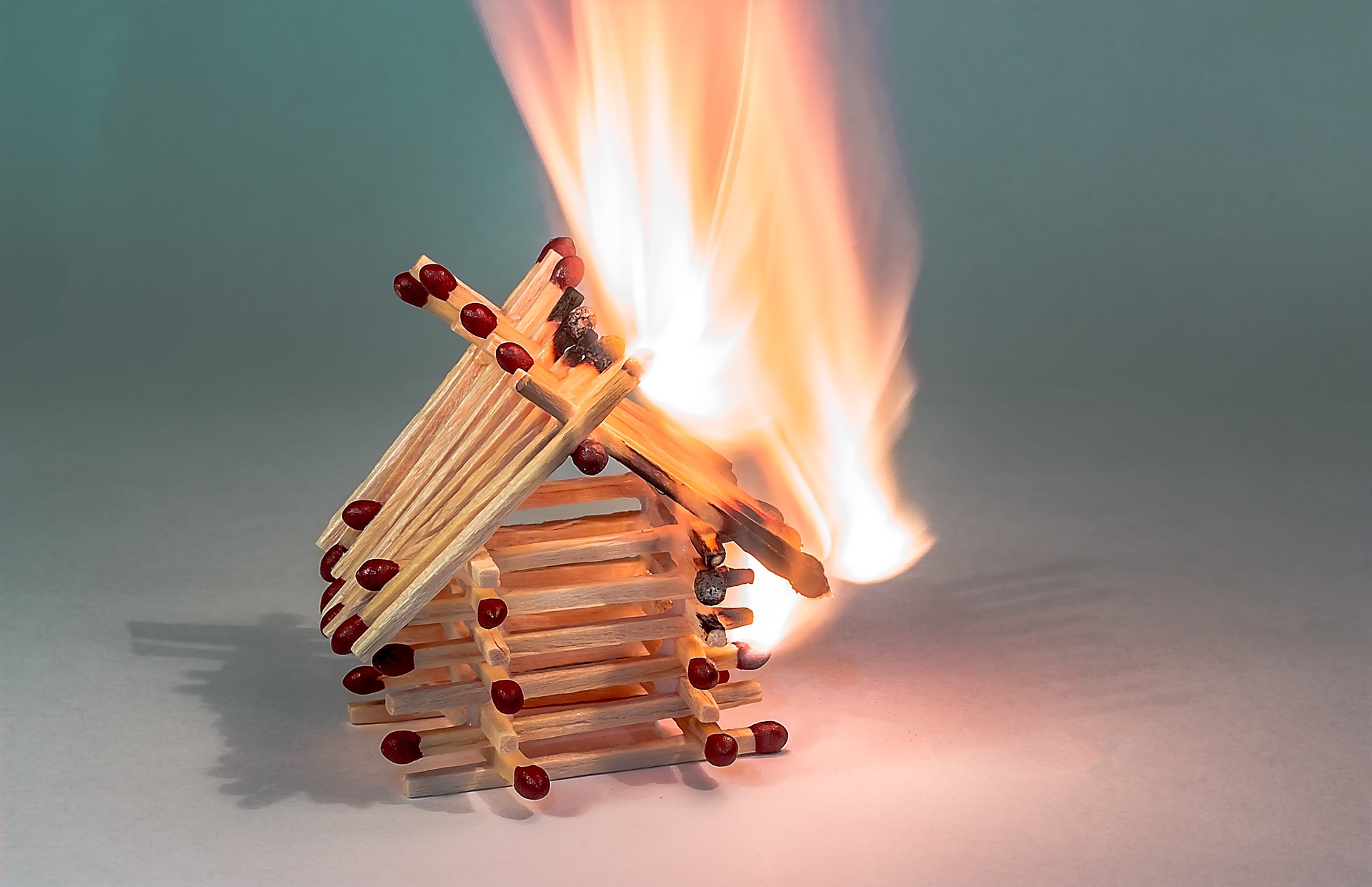 A house made of matchsticks on fire