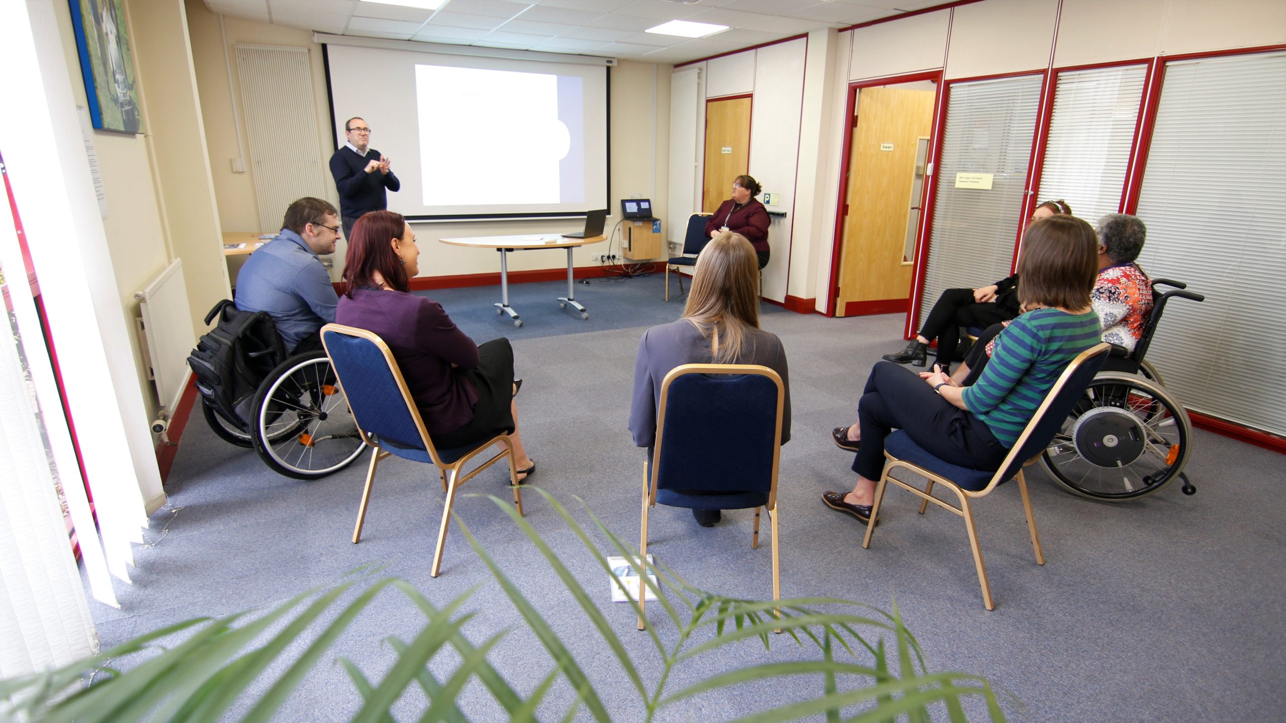 Swan room at the Living Options Devon office. A group of people undertaking Deaf Awareness Training