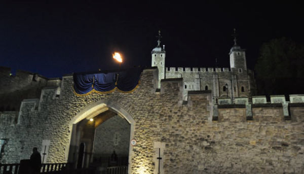 The Tower of London with a burning fire beacon brasier above the main gate