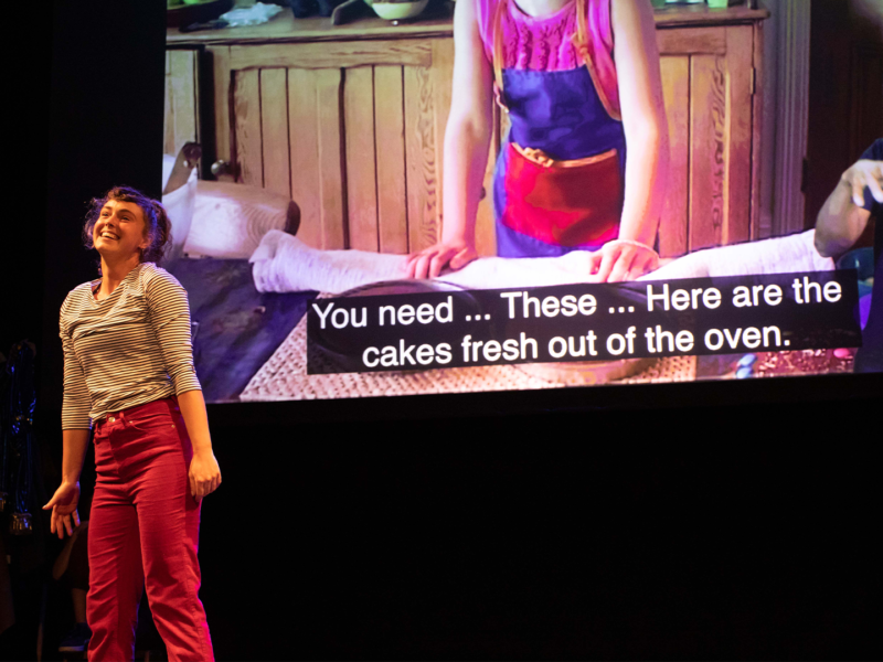A previous accessible performance at the Northcott - actor with a captioned screen behind them