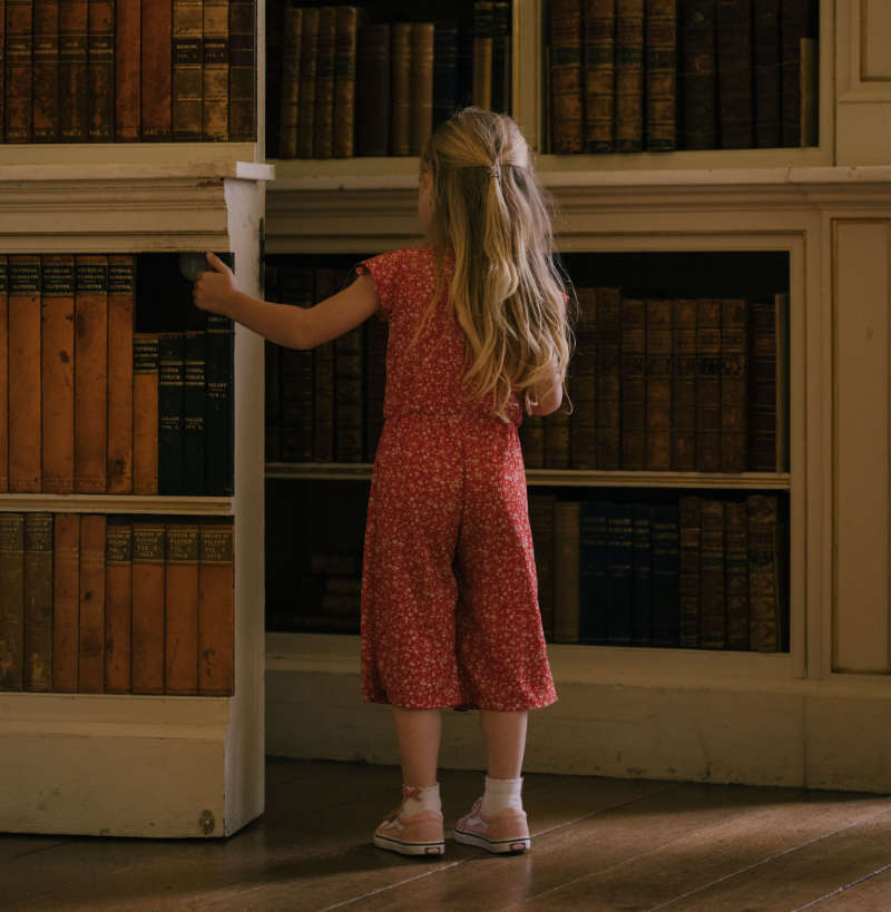 Powderham Castle quiet hour - young girl exploring the library