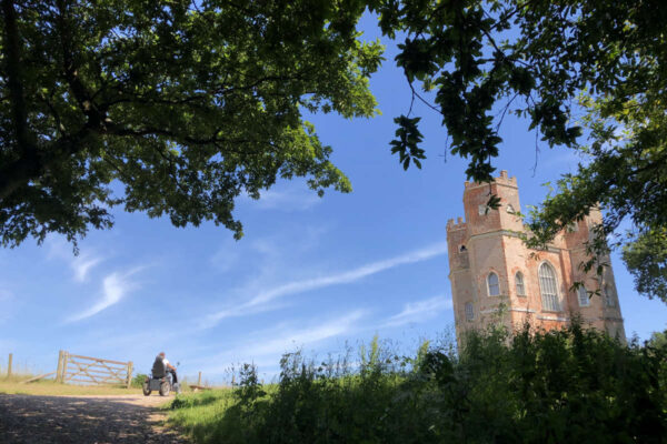 Powderham belvedere tower with blue sky and tramper