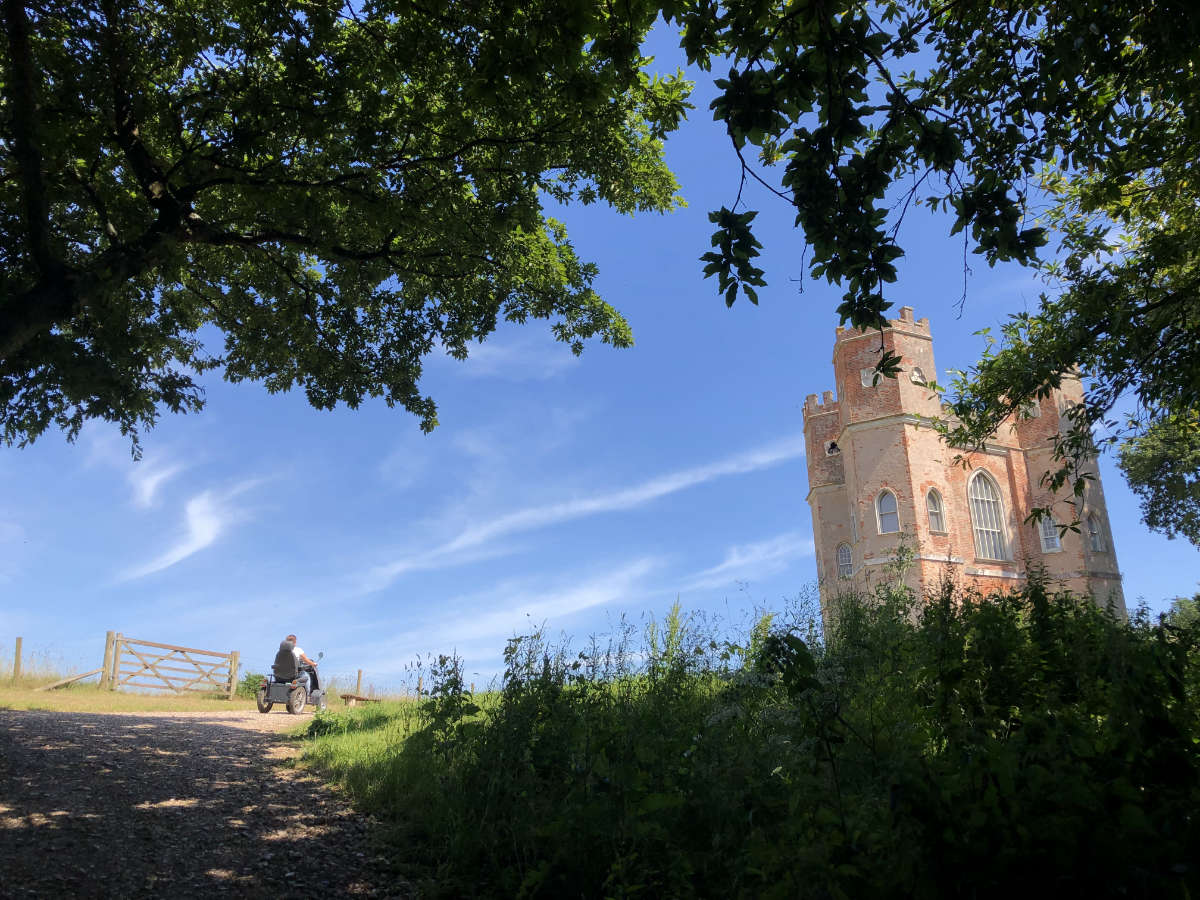 Powderham belvedere tower with blue sky and tramper