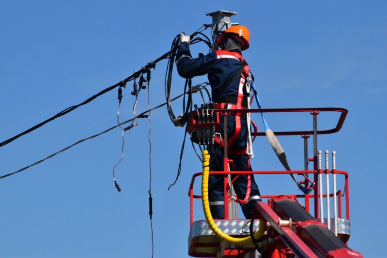 worker fixing a power line