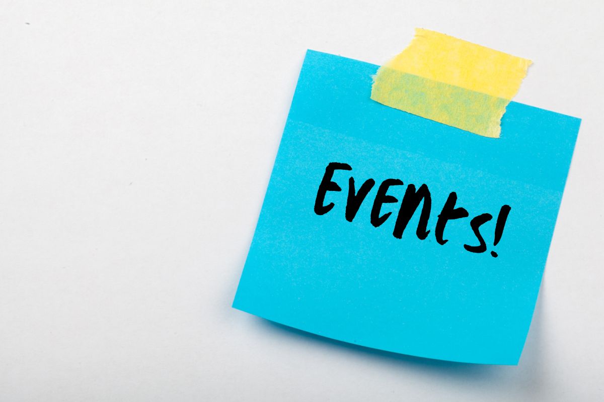 A blue post it note attached with sticky tape that says events on it