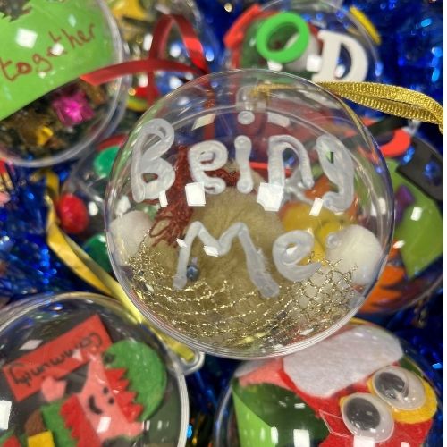A colourful bauble with the words Being Me