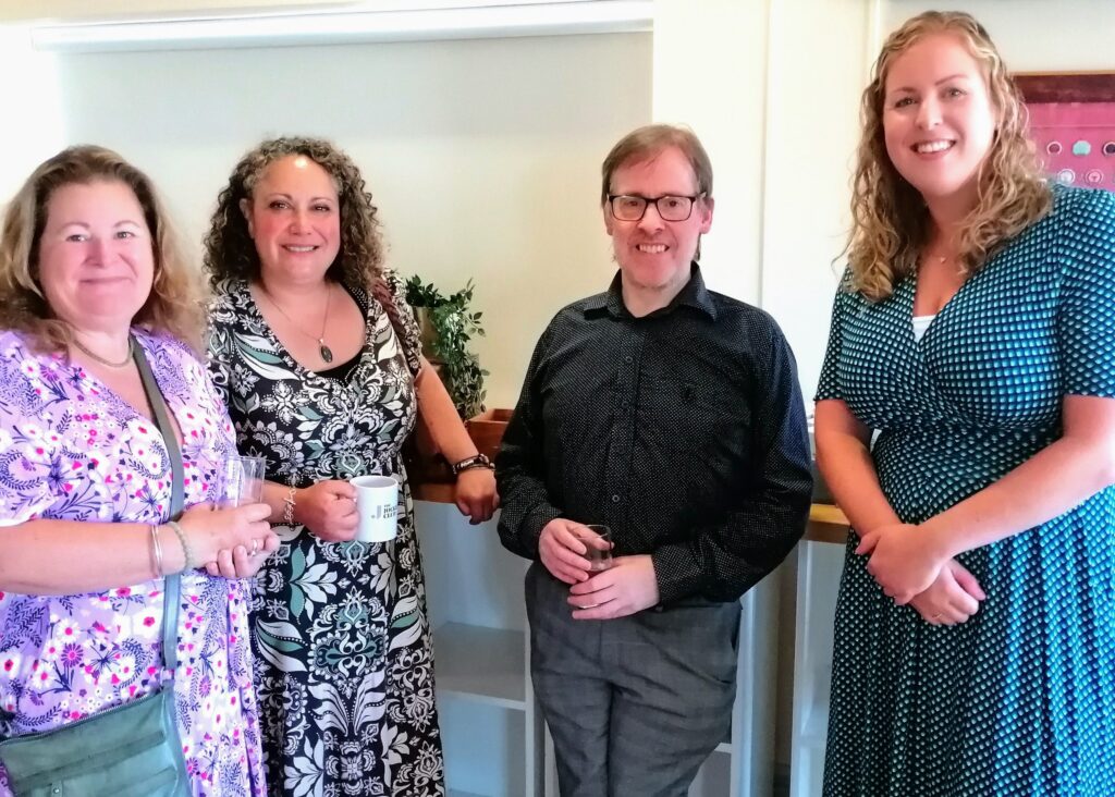 Megan, Laila, Andrew Barge, and Stephanie are standing together, smiling at the camera